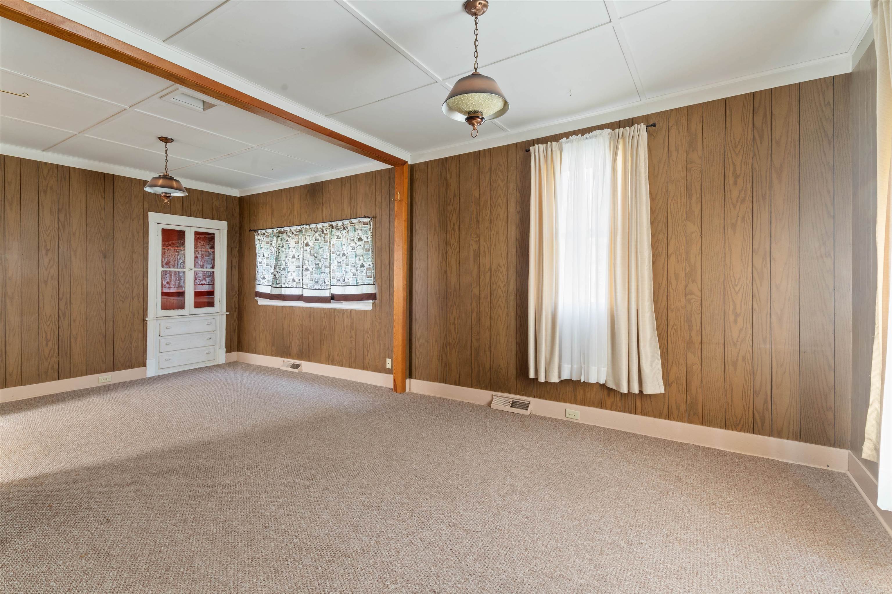 1301 North 11th Street Superior, WI 54880 - Photo 2 of 21 Carpeted empty room featuring wooden walls and baseboards