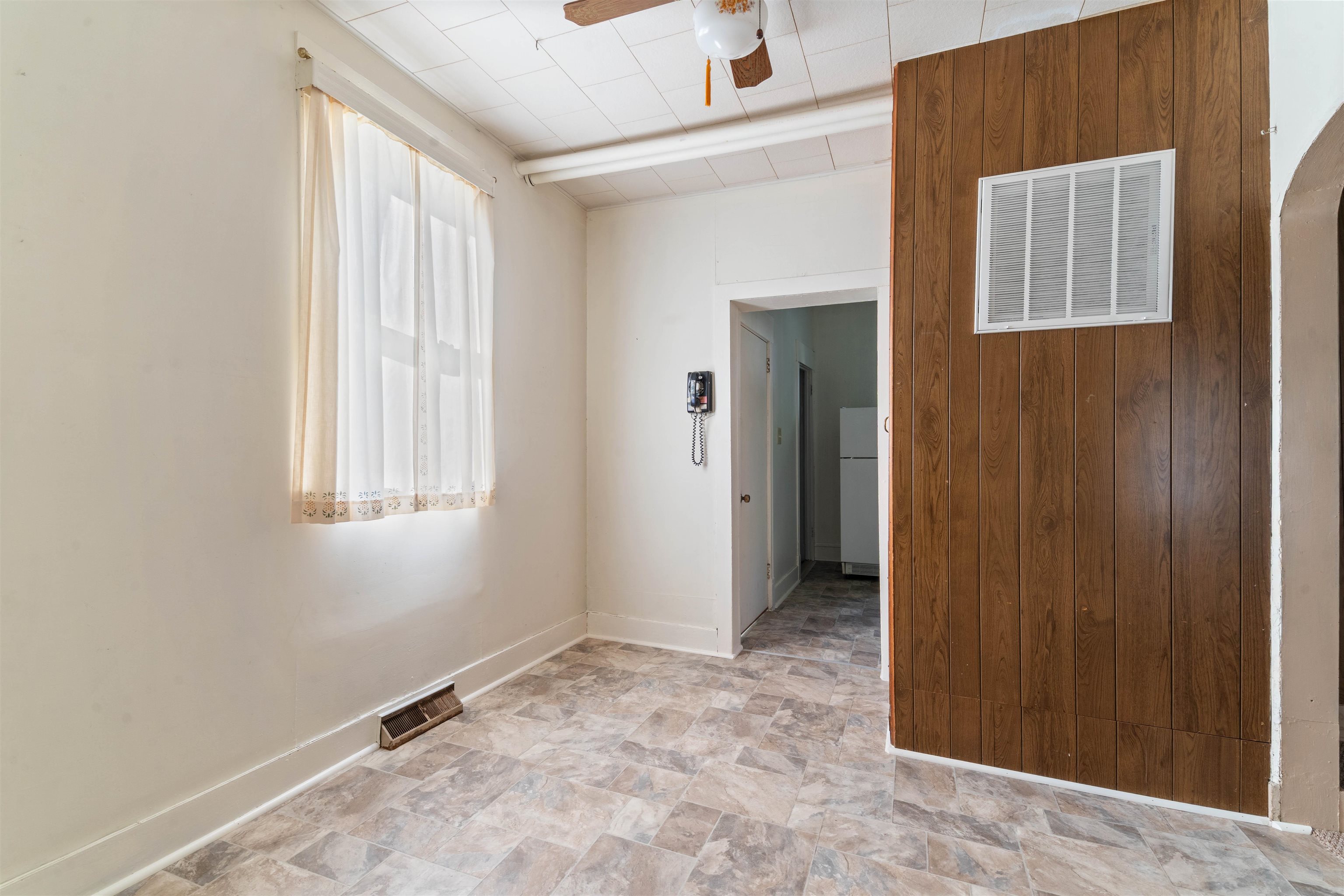 1301 North 11th Street Superior, WI 54880 - Photo 4 of 21 Spare room featuring stone finish floors, ceiling fan, and arched walkways