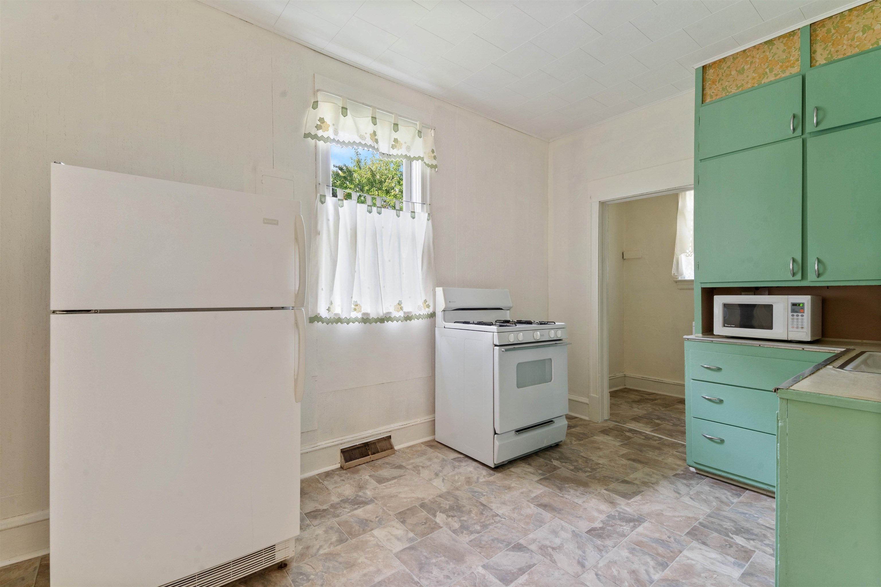 1301 North 11th Street Superior, WI 54880 - Photo 5 of 21 Kitchen featuring green cabinetry, white appliances, light countertops, and stone finish floors
