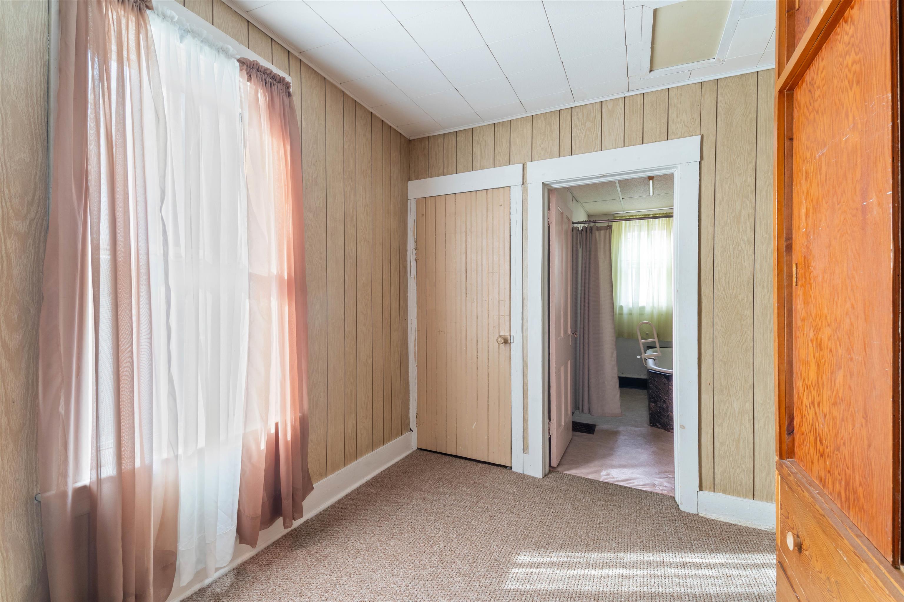 1301 North 11th Street Superior, WI 54880 - Photo 9 of 21 Spare room with wood walls and carpet