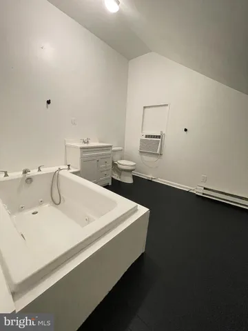 a bathroom with a toilet a sink and a bathtub