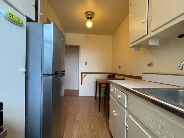 a kitchen with a refrigerator and a sink