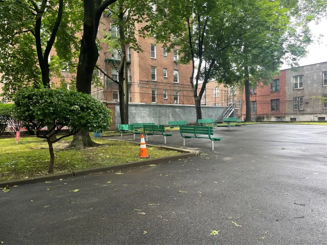 a front view of a building with a garden