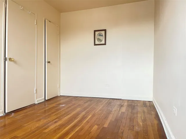 a view of a room with wooden floor
