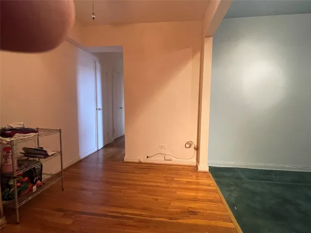 an empty room with wooden floor and closet