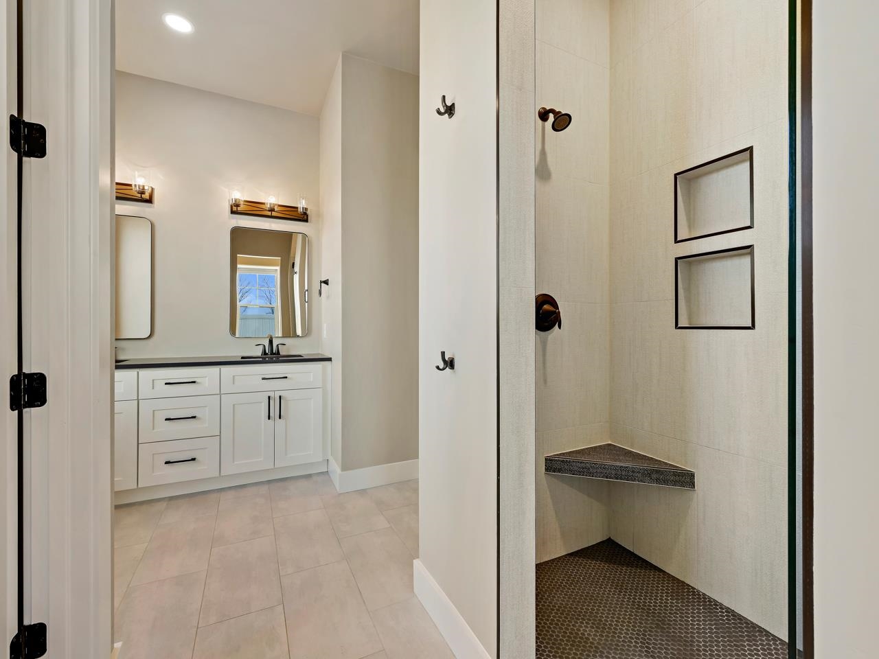 823 Red Apple Road Grand Junction, CO 81505 - Photo 17 of 38 a bathroom with a granite countertop sink a mirror and a bathtub