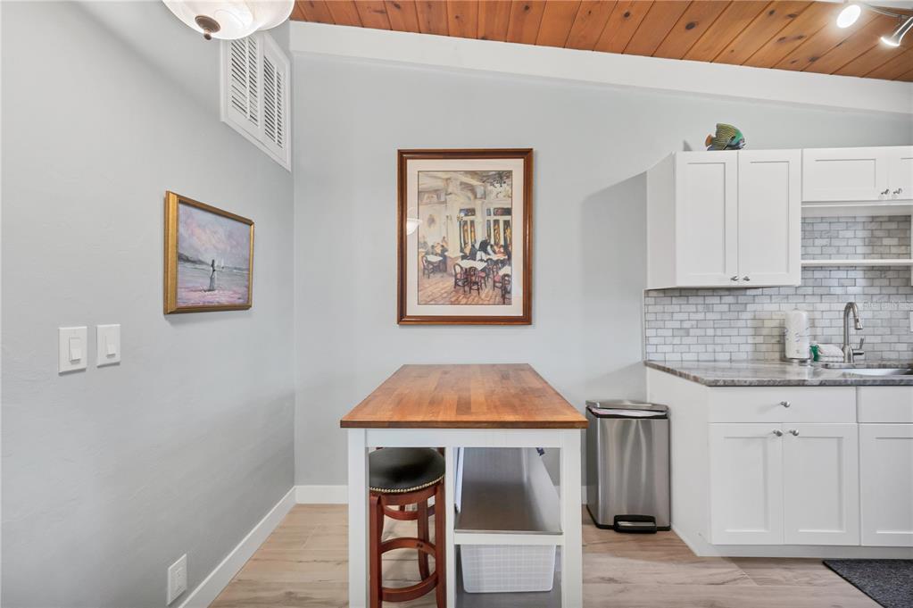6006 Midnight Pass Road, Unit 21 Sarasota, FL 34242 - Photo 11 of 24 a kitchen with a sink cabinets and wooden floor