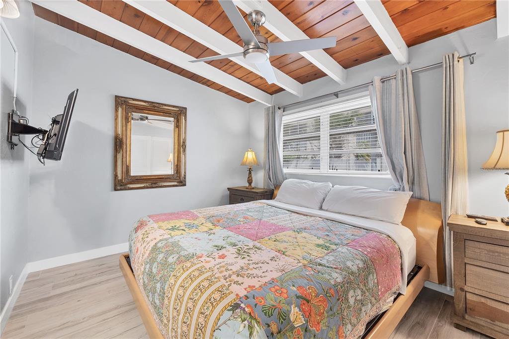 6006 Midnight Pass Road, Unit 21 Sarasota, FL 34242 - Photo 12 of 24 a bedroom with bed and window