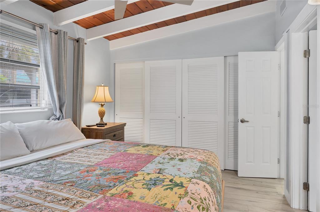 6006 Midnight Pass Road, Unit 21 Sarasota, FL 34242 - Photo 13 of 24 a bedroom with a large bed and a window