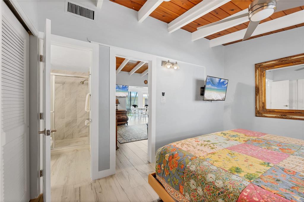 6006 Midnight Pass Road, Unit 21 Sarasota, FL 34242 - Photo 14 of 24 a bedroom with a bed and a window