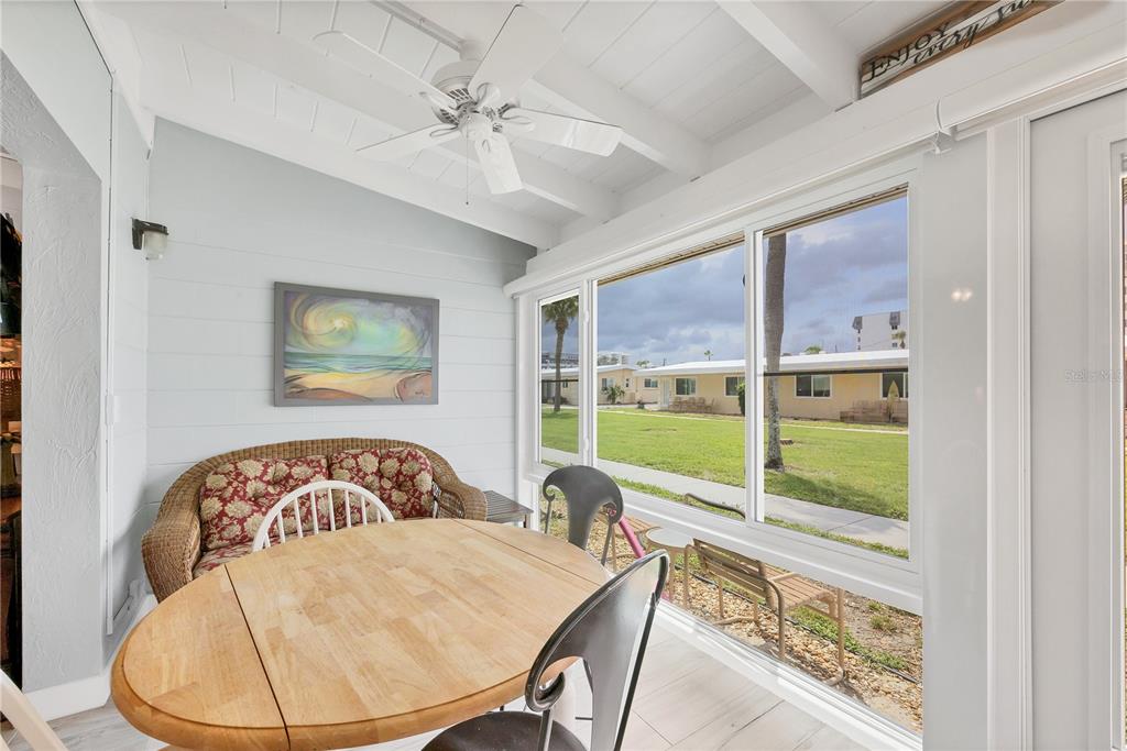 6006 Midnight Pass Road, Unit 21 Sarasota, FL 34242 - Photo 18 of 24 a view of a dining room with furniture a chandelier and wooden floor