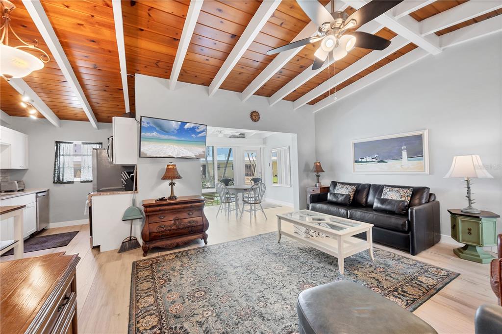 6006 Midnight Pass Road, Unit 21 Sarasota, FL 34242 - Photo 4 of 24 a living room with furniture and a wooden floor