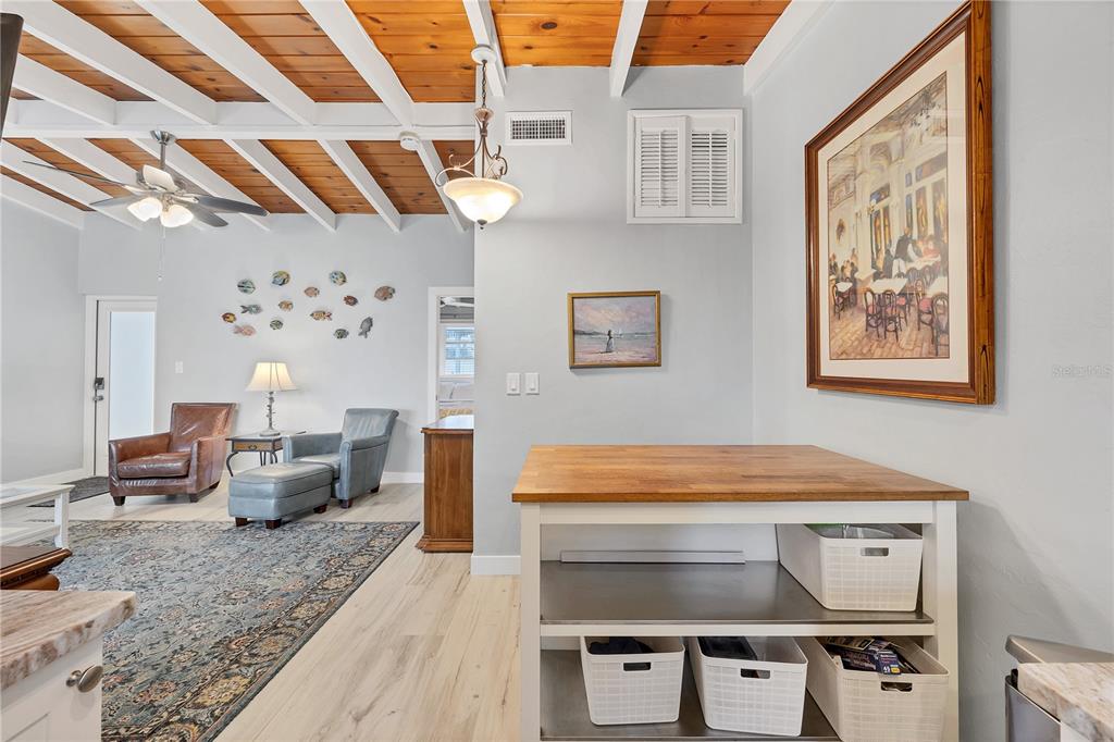 6006 Midnight Pass Road, Unit 21 Sarasota, FL 34242 - Photo 10 of 24 a bedroom with furniture and wooden floor