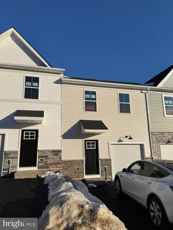 a front view of a house with parking space