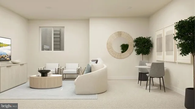 a living room with couches and a potted plant
