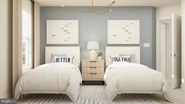 a bedroom with two beds and a window