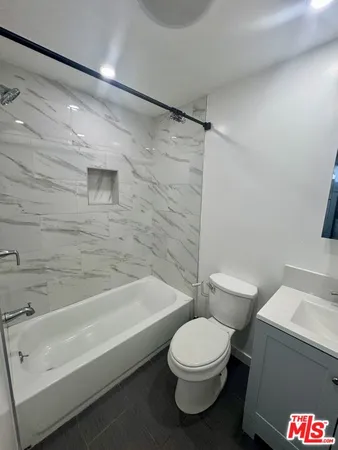 a bathroom with a toilet and a bathtub