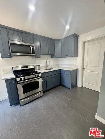a kitchen with stainless steel appliances and cabinets