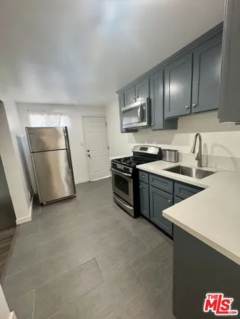 a kitchen that has a sink and a stove