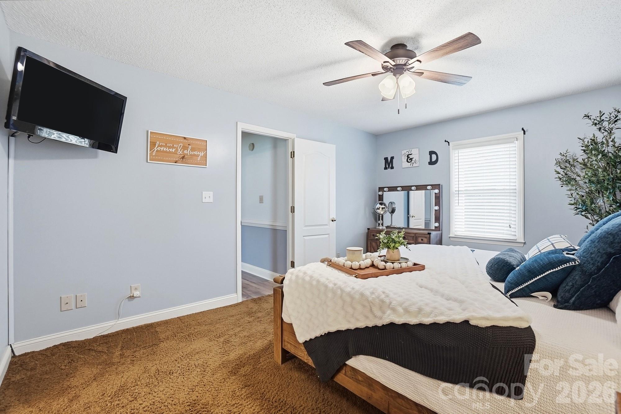 4017 Mullis Newsome Road Monroe, NC 28110 - Photo 25 of 38 a bedroom with a bed and a chandelier