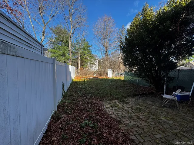 a view of a backyard with sitting area