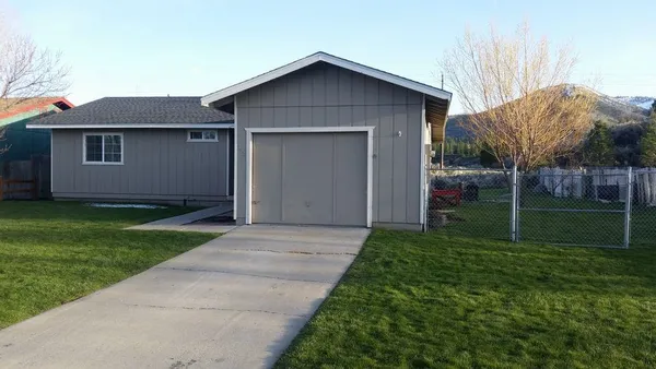 a view of a house with yard and a garden