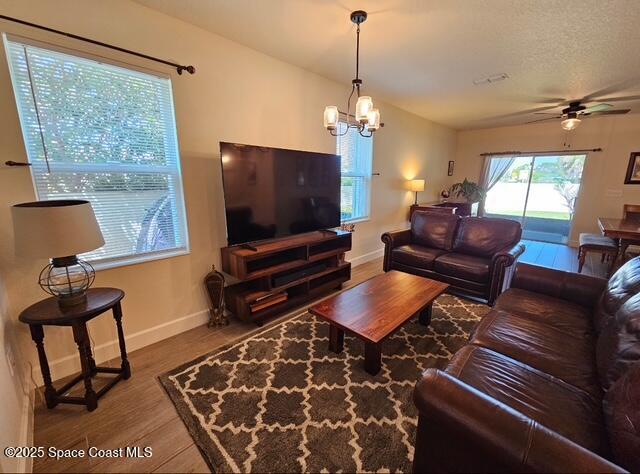 1807 Elkins Point Melbourne, FL 32935 - Photo 6 of 13 a living room with furniture a piano and a flat screen tv