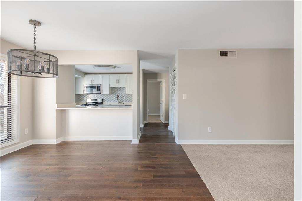 1211 Wynnes Ridge Circle Marietta, GA 30067 - Photo 13 of 35 a view of a kitchen with wooden floor and a refrigerator