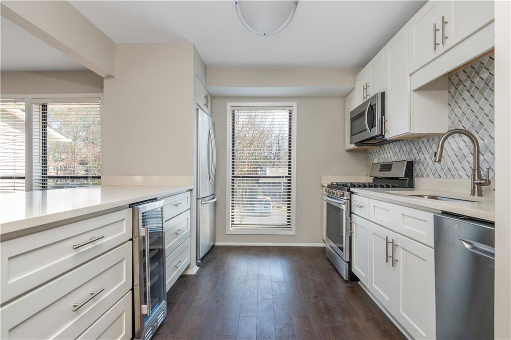 1211 Wynnes Ridge Circle Marietta, GA 30067 - Photo 15 of 35 a kitchen with stainless steel appliances granite countertop a stove and a sink