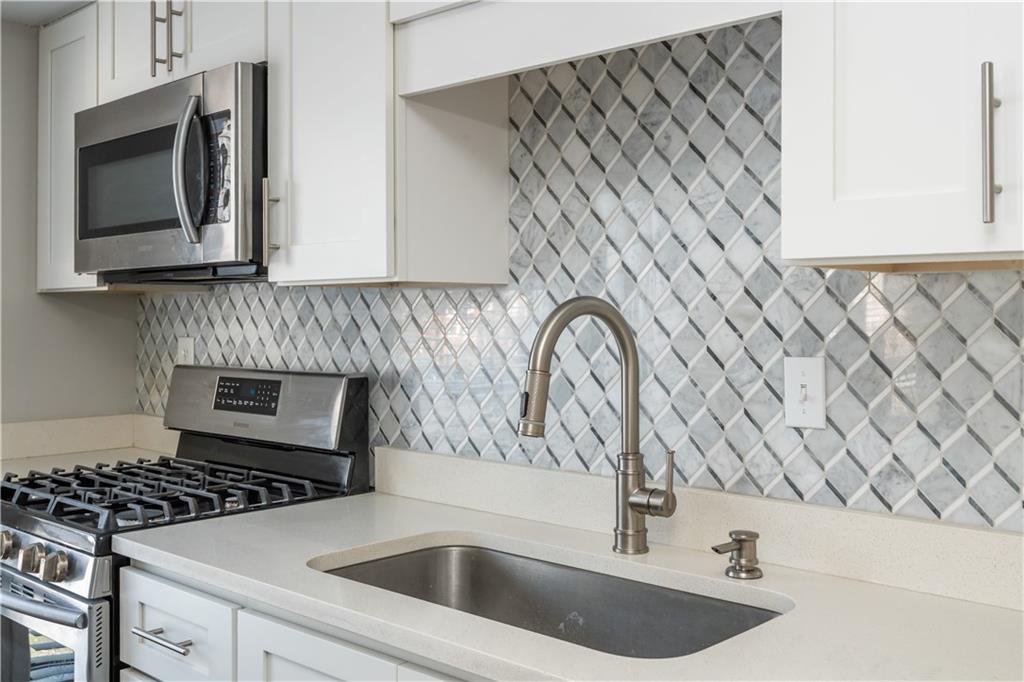 1211 Wynnes Ridge Circle Marietta, GA 30067 - Photo 16 of 35 a kitchen with cabinets and a stove top oven