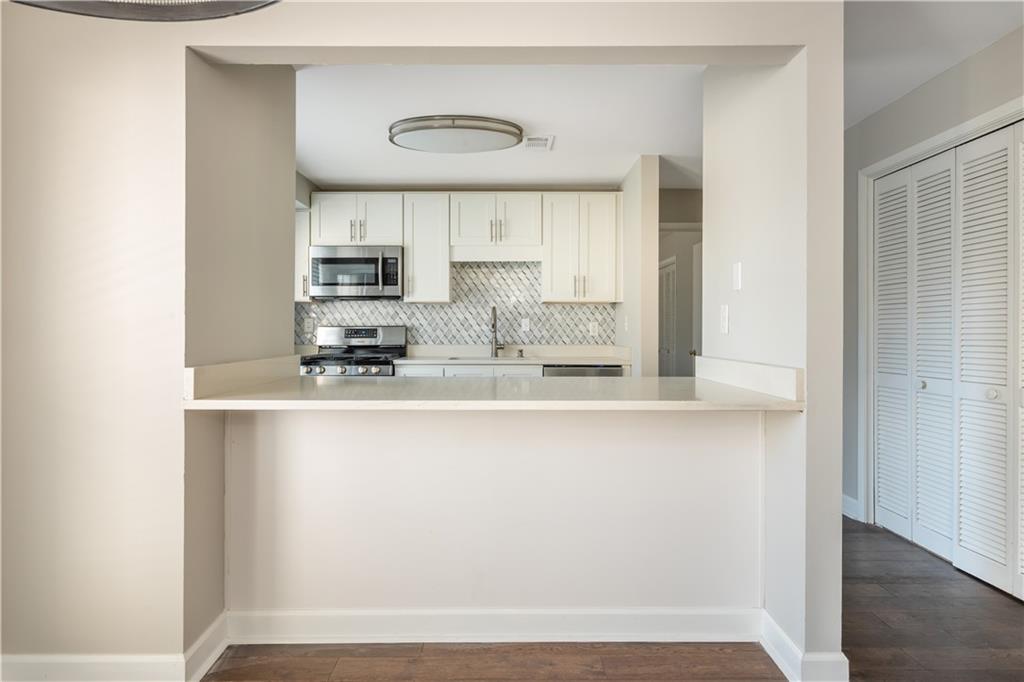 1211 Wynnes Ridge Circle Marietta, GA 30067 - Photo 17 of 35 a kitchen with stainless steel appliances a refrigerator and white cabinets