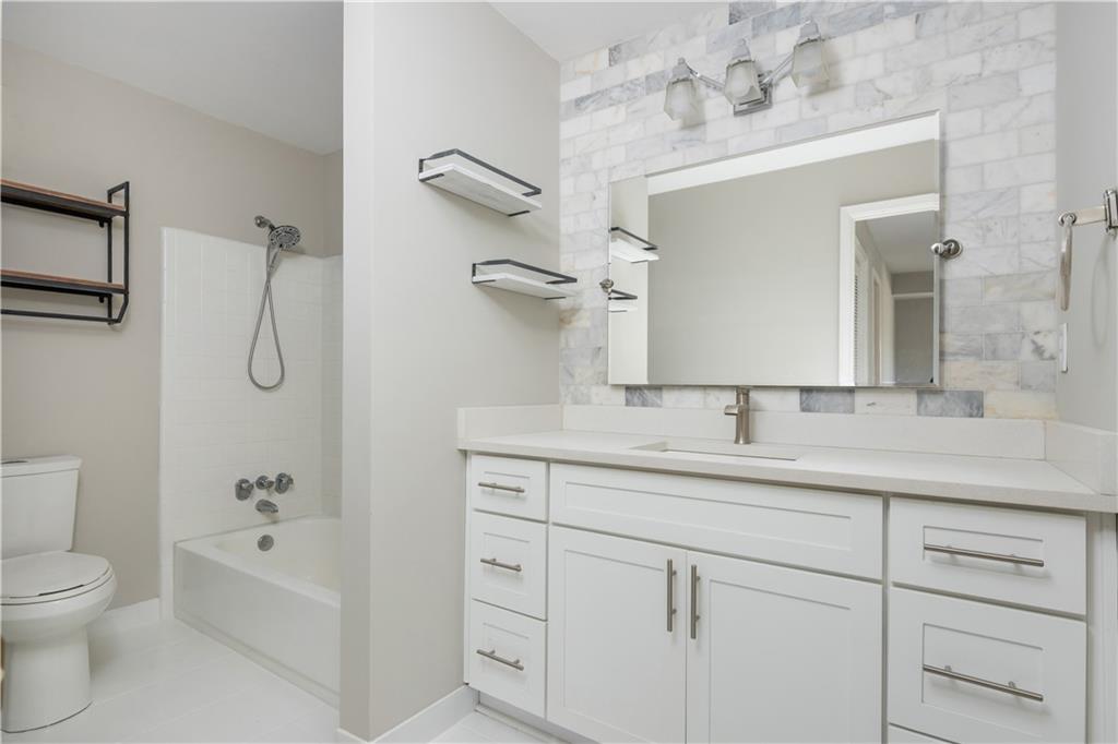 1211 Wynnes Ridge Circle Marietta, GA 30067 - Photo 26 of 35 a bathroom with a double vanity sink toilet mirror and bathtub