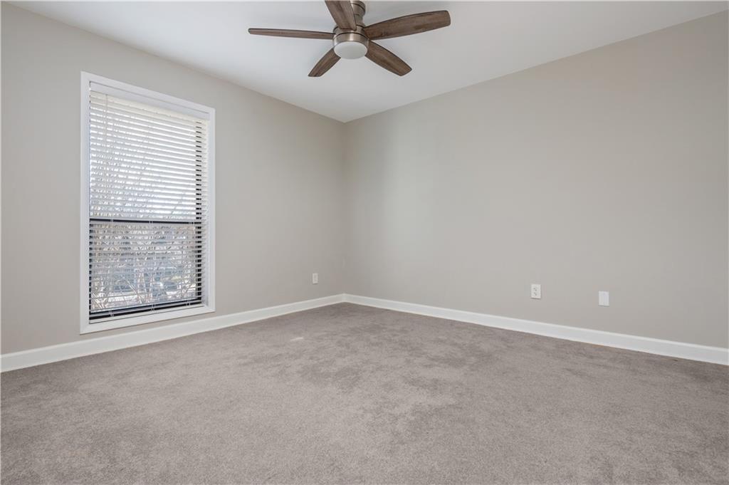 1211 Wynnes Ridge Circle Marietta, GA 30067 - Photo 27 of 35 an empty room with a window and a fan