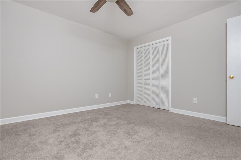 1211 Wynnes Ridge Circle Marietta, GA 30067 - Photo 28 of 35 an empty room with ceiling fan and window