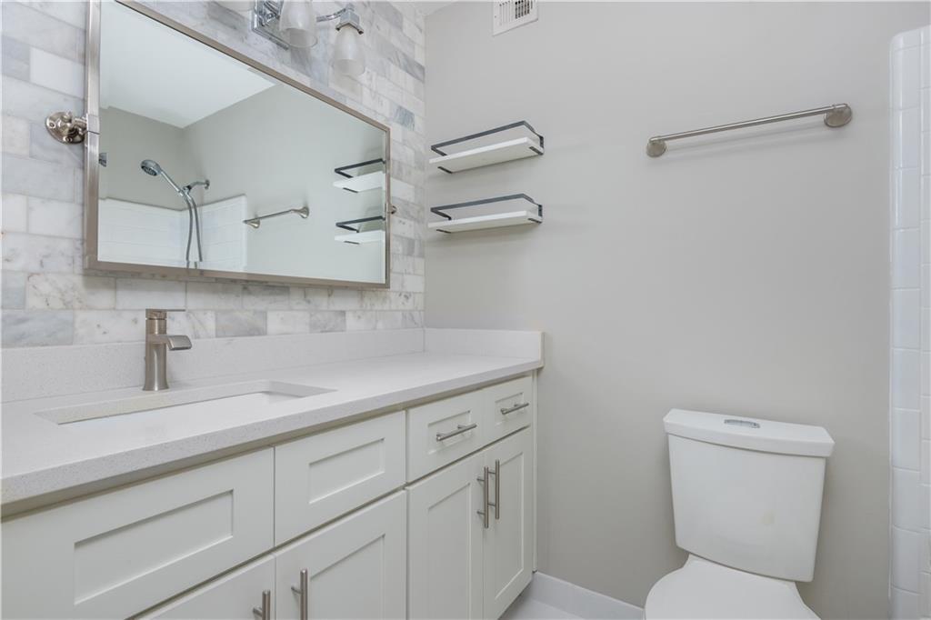 1211 Wynnes Ridge Circle Marietta, GA 30067 - Photo 29 of 35 a bathroom with a toilet sink and mirror