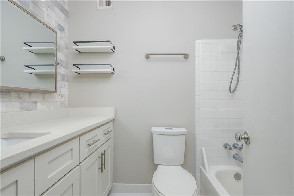 1211 Wynnes Ridge Circle Marietta, GA 30067 - Photo 30 of 35 a bathroom with a sink a toilet and shower