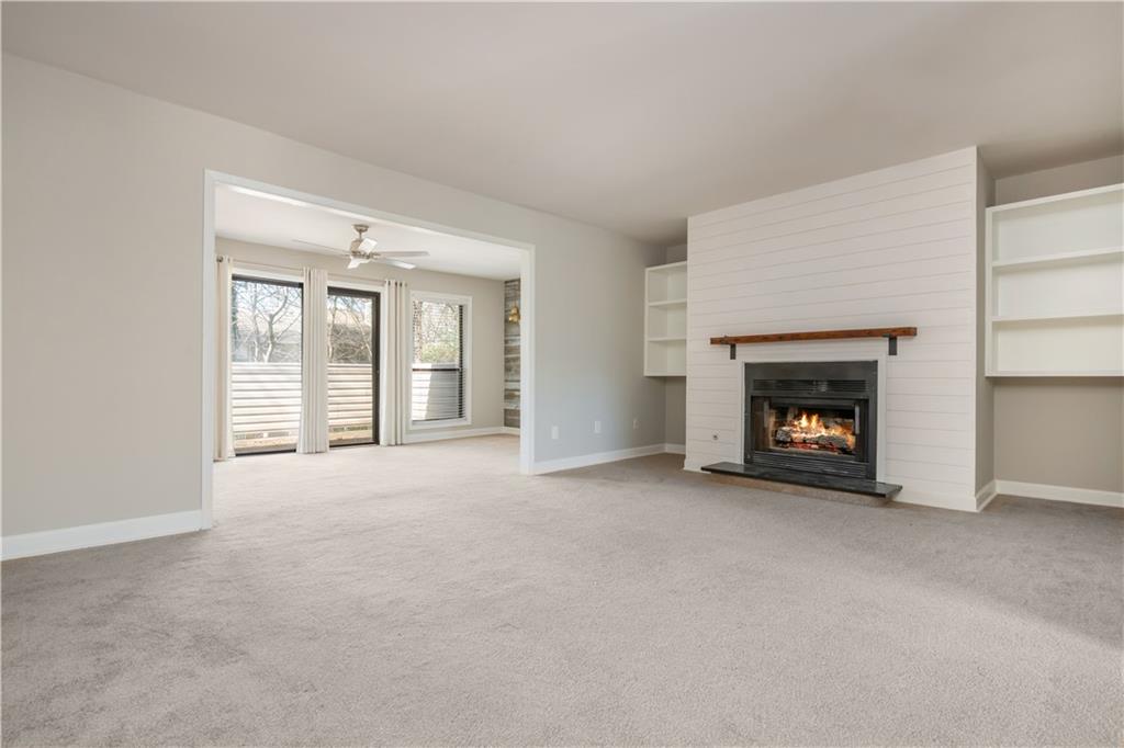 1211 Wynnes Ridge Circle Marietta, GA 30067 - Photo 8 of 35 a view of an empty room with a fireplace and a window