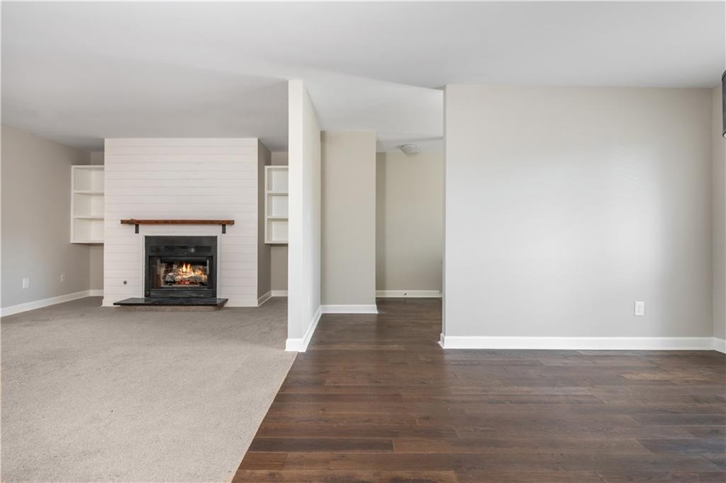 1211 Wynnes Ridge Circle Marietta, GA 30067 - Photo 10 of 35 a view of an empty room with wooden floor fireplace and a window