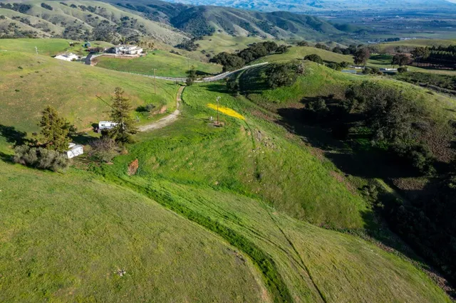 a view of a ocean with mountains in the background