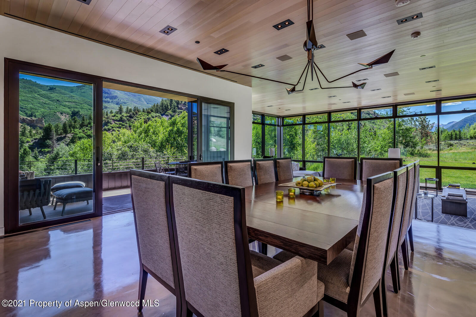 276 Coach Road Aspen, CO 81611 - Photo 11 of 68 a view of a dining room with furniture large windows and wooden floor
