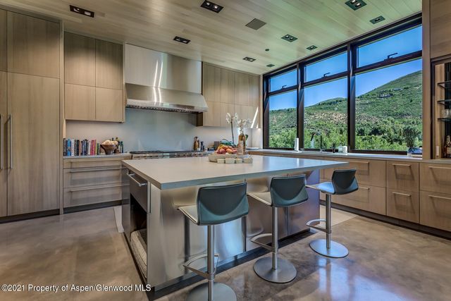 a kitchen with a stove a table and chairs