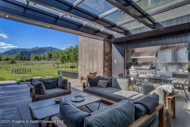 a living room with furniture and large windows