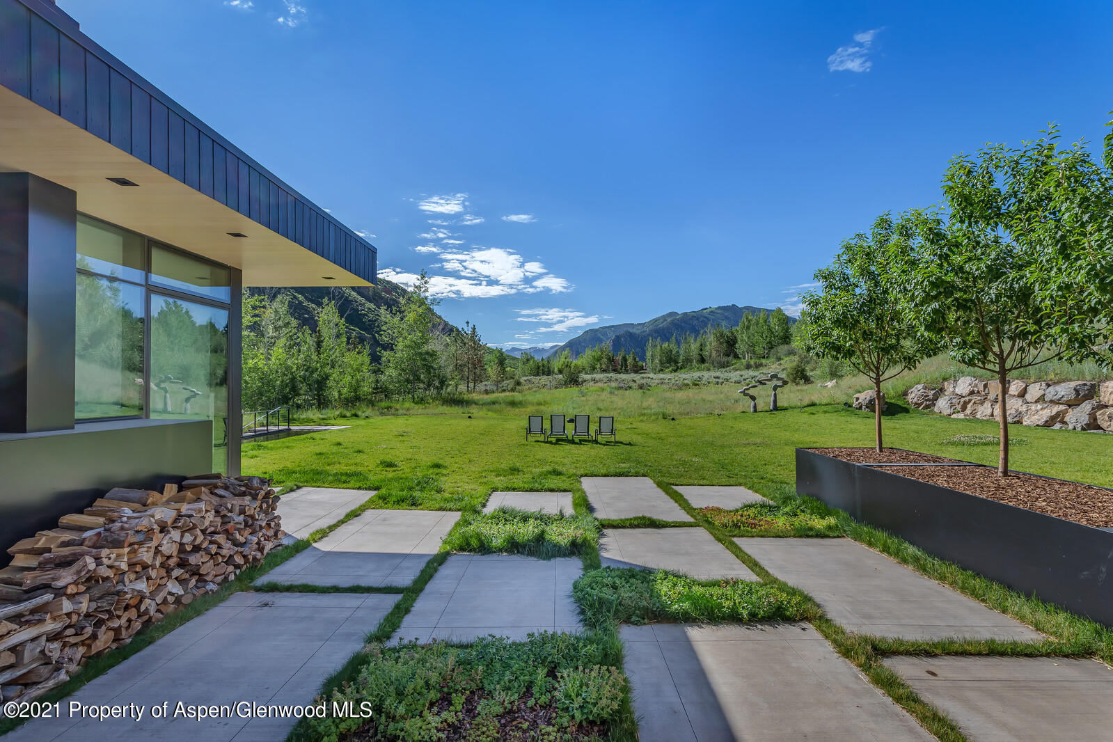 276 Coach Road Aspen, CO 81611 - Photo 22 of 68 a view of a house with garden and a patio