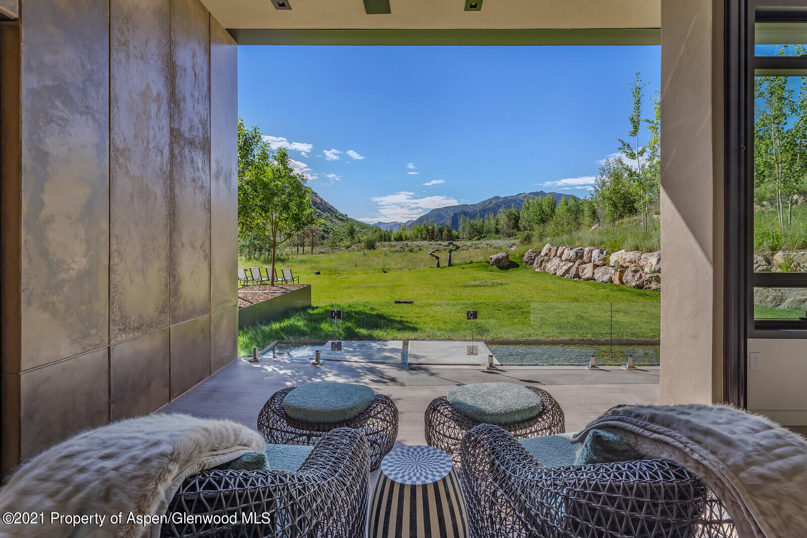 276 Coach Road Aspen, CO 81611 - Photo 31 of 68 a view of a patio with table and chairs potted plants with wooden floor