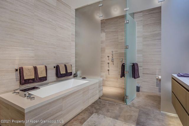 a room with wooden floor pool table and furniture
