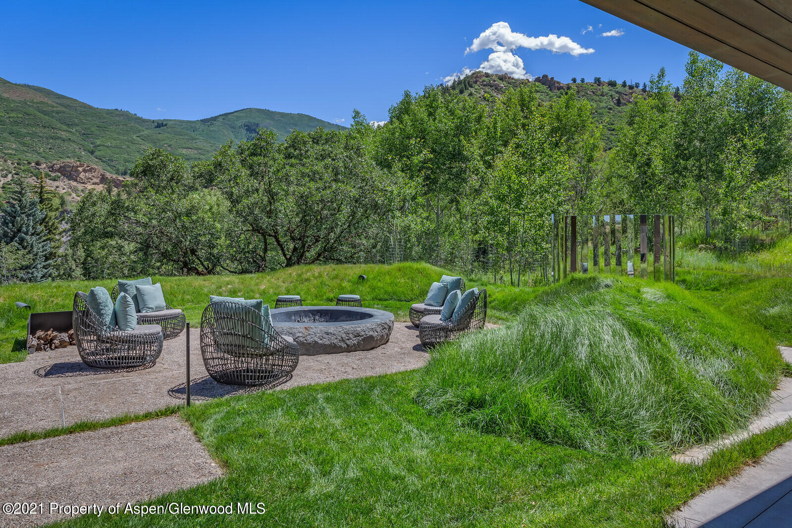 276 Coach Road Aspen, CO 81611 - Photo 46 of 68 a view of an chairs and table in the back yard