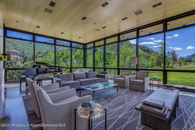 a living room with furniture and a floor to ceiling window