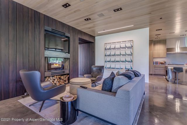 a living room with lots of furniture and a large window