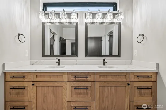 a bathroom with a sink vanity and a mirror