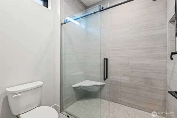 a bathroom with a toilet and a shower